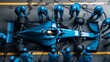 © master1305 - View from above, car receives rapid servicing from dedicated pit crew in blue gear. Coordination and efficiency required to maintain competitive edge in racing.