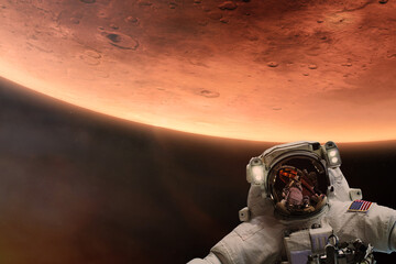 Wall Mural - cosmonaut in deep space with mars planet background. elements of this image furnished by nasa.