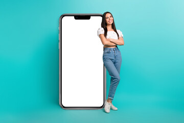 Poster - Full length photo of cute confident girl dressed white top reading apple iphone samsung device empty space isolated teal color background