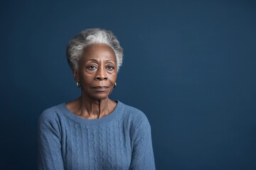 Indigo background sad black American independent powerful Woman. Portrait of older mid-aged person beautiful bad mood expression girl Isolated on Background