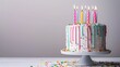 © WACHI - Colorful birthday cake with lit candles on white background.Birthday