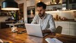 © ZeNDaY - Young Professional Working on Laptop in Stylish Kitchen Setting with Coffee, Notebook, and Smartphone, Cozy Living Room in Background