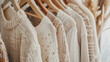 © Klay - variety of summer clothes on hangers, featuring neutral colors and natural textures for a relaxed look