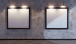 © Mudasir - In a contemporary architectural studio, two white frames with dark borders are displayed against a wall with a stucco finish.