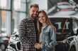© barmaleeva - Couple choosing car in dealership salon
