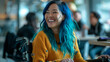 © Sophie  - Happy candid female employee with blue hair sitting in wheelchair laughing with colleagues relaxed office team induction meeting. Inclusion & diversity accessible workplace. Celebrating differences