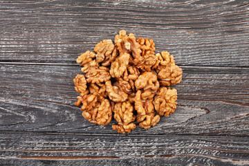 Wall Mural - walnuts heap on wood background top view