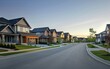 © Tui - Suburban street lined with modern, neat single-family homes under a clear sky.