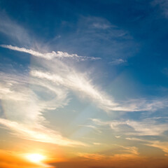 Wall Mural - Blue sky with cirrus clouds and sunrise.