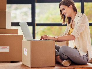 Wall Mural - Happy, woman and laptop with boxes for moving day, real estate and house relocation for planning and contact. Smile, female person and computer on parcel for email about investment and mortgage