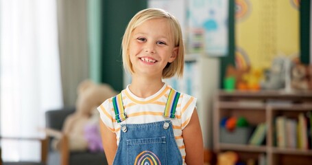 Fototapete - Girl, child and face or happy in classroom for education, knowledge or fun learning with confidence. Student, person and portrait with smile at kindergarten for studying, pride and academy or school