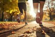 © Stavros - Keeping fit in any age. Jogging workout in autumn forest. Legs close up. Couple during jogging workout in an autumn city park.