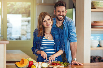 Wall Mural - Happy, couple and cooking healthy meal for nutrition, diet and wellness as vegan lunch at house with love. Smile, woman and man cutting vegetables for organic, food and romance together on weekend