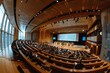 © Aliaksandr Siamko - A large auditorium filled with people watching a presentation