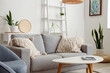 © Pixel-Shot - Interior of living room with cozy grey sofa and coffee table