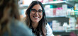 © Edgar Martirosyan - Female pharmacy worker smiling while talking to a customer in the store.