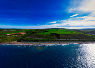 Wall Mural - Aerial View of Coastal Landscape with Beach and Green Fields in Sandsend, Yorkshire