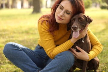 Wall Mural - Woman with her cute German Shorthaired Pointer dog in park on spring day