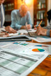 © Starmarpro - Financial reporting and audit concept. Bills charts statements and business people arrounf the table. High quality photo