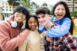 © Xavier Lorenzo - Cheerful multiracial group of young students friends smiling at camera while standing outdoors at campus university. Education and millennial people concept