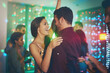 © peopleimages.com - Couple, celebrate and dance in club at night on date with love in marriage or relationship. People, hug and embrace together with happiness at neon disco, party or rave at techno music festival