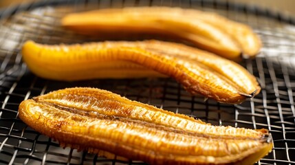 Poster - on a round white grill dried banana closeup : Generative AI
