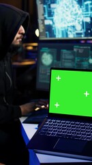 Poster - vertical video isolated screen laptop used by cybercriminal in underground hideout to write lines of
