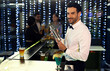 © peopleimages.com - Club, portrait and bartender with cocktail shaker for alcohol drink, mixing or hospitality at counter. Barman, mixologist or male person with confidence for martini, service or liquor with nightlife
