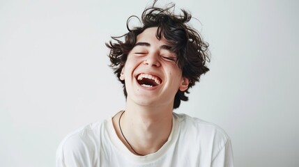 Sticker - Close up view of a teenage boy with curly hair, isolated on a plain gray background. White shirt.