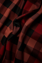Red And Black Checkered Fabric With Black Stripe.