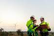 © eakgrungenerd - Engineer wearing safety uniform using tablet discussed plan about renewable energy at station energy power wind turbine. technology protect environment reduce global warming problems.
