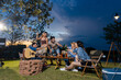 © Kawee - Group of diverse friend having outdoors camping party together in tent.