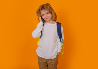 Aufkleber - Child using mobile phone, tell, talk on the phone over yellow background.