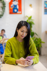 Sticker - Woman use smart phone in coffee shop