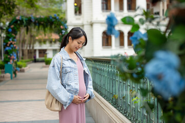 Canvas Print - Pregnant woman look at her belly at outdoor