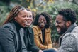 © Inigo - Group of happy young african american friends having fun together outdoors.