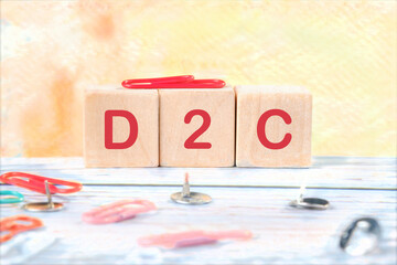 Concept of D2C (Direct to customer), word D2C on wooden cubes on a bright and beautiful background