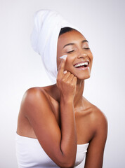 Sticker - Lotion, skincare and towel with smile of Indian woman in studio on white background for hygiene. Cleaning, cream and shower with happy model in bathroom to apply moisturizer to face for hydration