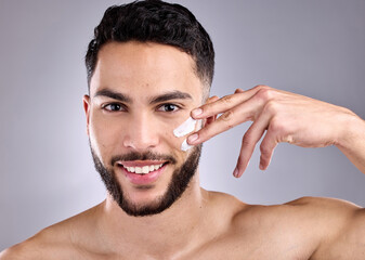 Canvas Print - Beauty, cream and smile with portrait of man on studio gray background for antiaging wellness. Aesthetic, change or transformation and face of happy model with lotion or moisturizer for dermatology