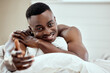 © peopleimages.com - Man, shirtless and bed with smile in portrait for morning gesture with hand, relax with peace for wellness. Male person, happiness and topless with fingers outstretched, calm with pillow or tired