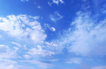 Clear blue sky texture and white fluffy cloud nature background. The sun shines bright in the daytime in summer