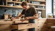 © ЮРИЙ ПОЗДНИКОВ - Man building kitchen drawer on wooden table with wood stain