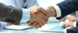 © Starkreal - Closeup of a business handshake over a conference table