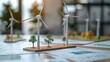 © Tanongsak - Scale models of wind turbines on a table with design schematics and a startups financial projections, symbolizing the integration of renewable energy and business innovation