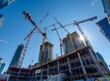 © DeepView - low angle photo of cranes and a building construction site