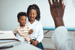 © Dragana Gordic - Happy young woman and her cute son looking at doctor and listening to his recommendations. Mother and baby son at a doctor´s appointment. Mother and her son  at the hospital talking to a doctor.