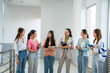 © mnirat - A group of women are standing together in a hallway