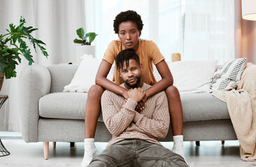 Canvas Print - Portrait, black couple and love in living room, man and woman with hug, romance or relax in home for break. House, African person and partner in lounge, embrace and serious of marriage and commitment