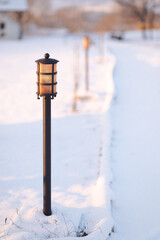 Poster - a street light covered in snow next to a road sign