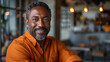 © ML - Handsome 40 50 years old black man smile and sitting in chair